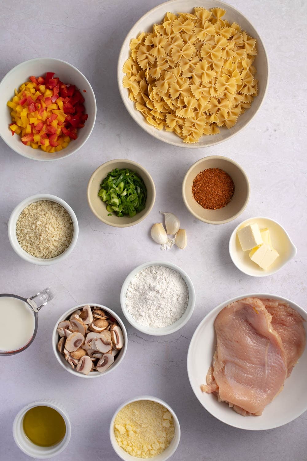 Chicken Pasta Ingredients - Chicken Breasts, Flour, Cajun Seasoning, Panko Breadcrumbs, Parmesan Cheese, Whole Milk, Mushrooms, Heavy Cream, Butter and Farfalle Pasta