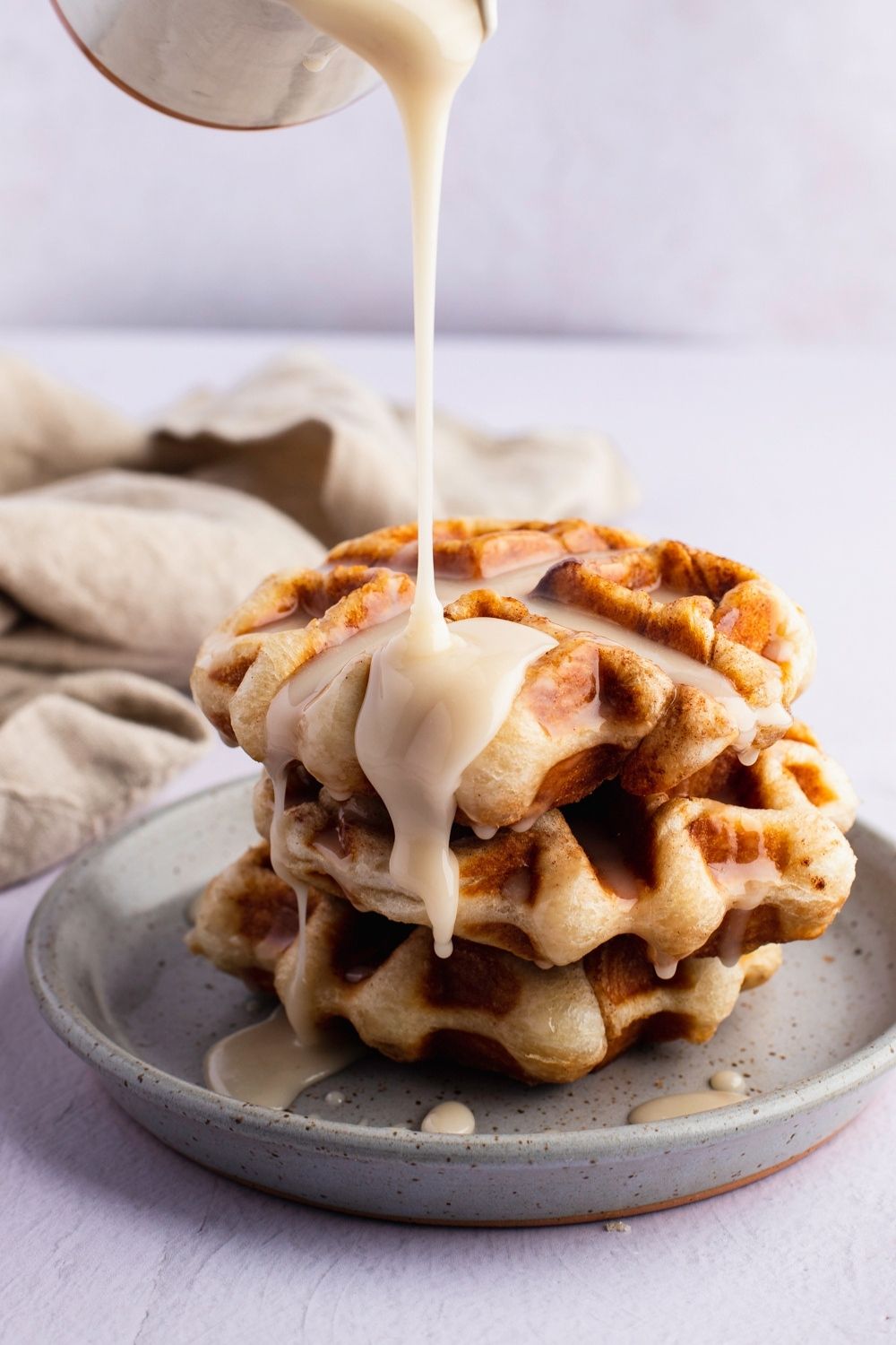 Dripping Cream Cheese Glaze Into Cinnamon Roll Waffles