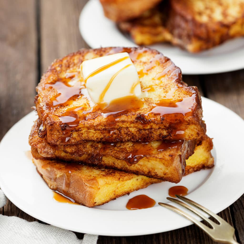 Eggnog French Toast Served With Melted Butter and Syrup on Top