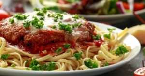 Homemade Chicken Parmesan with Marinara Sauce and Pasta in a Plate